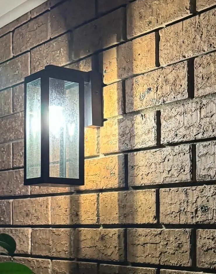 Outdoor wall sconce mounted on brickwork at a Redwood Park home