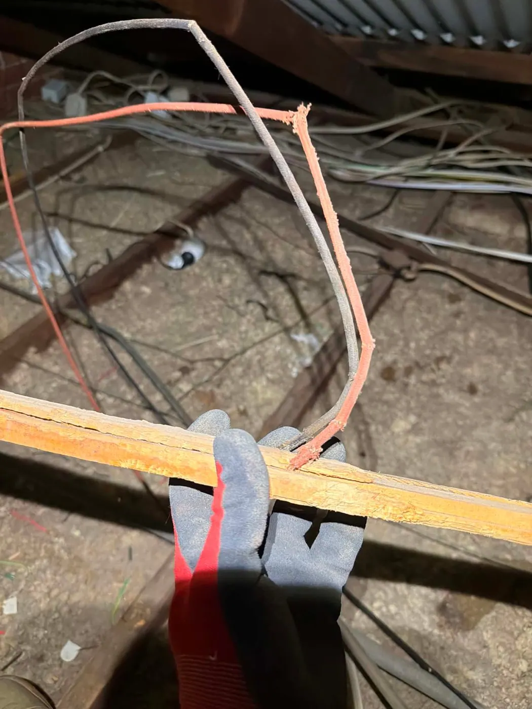 Close-up of cotton-braided electrical cable with the outer braid frayed and split open