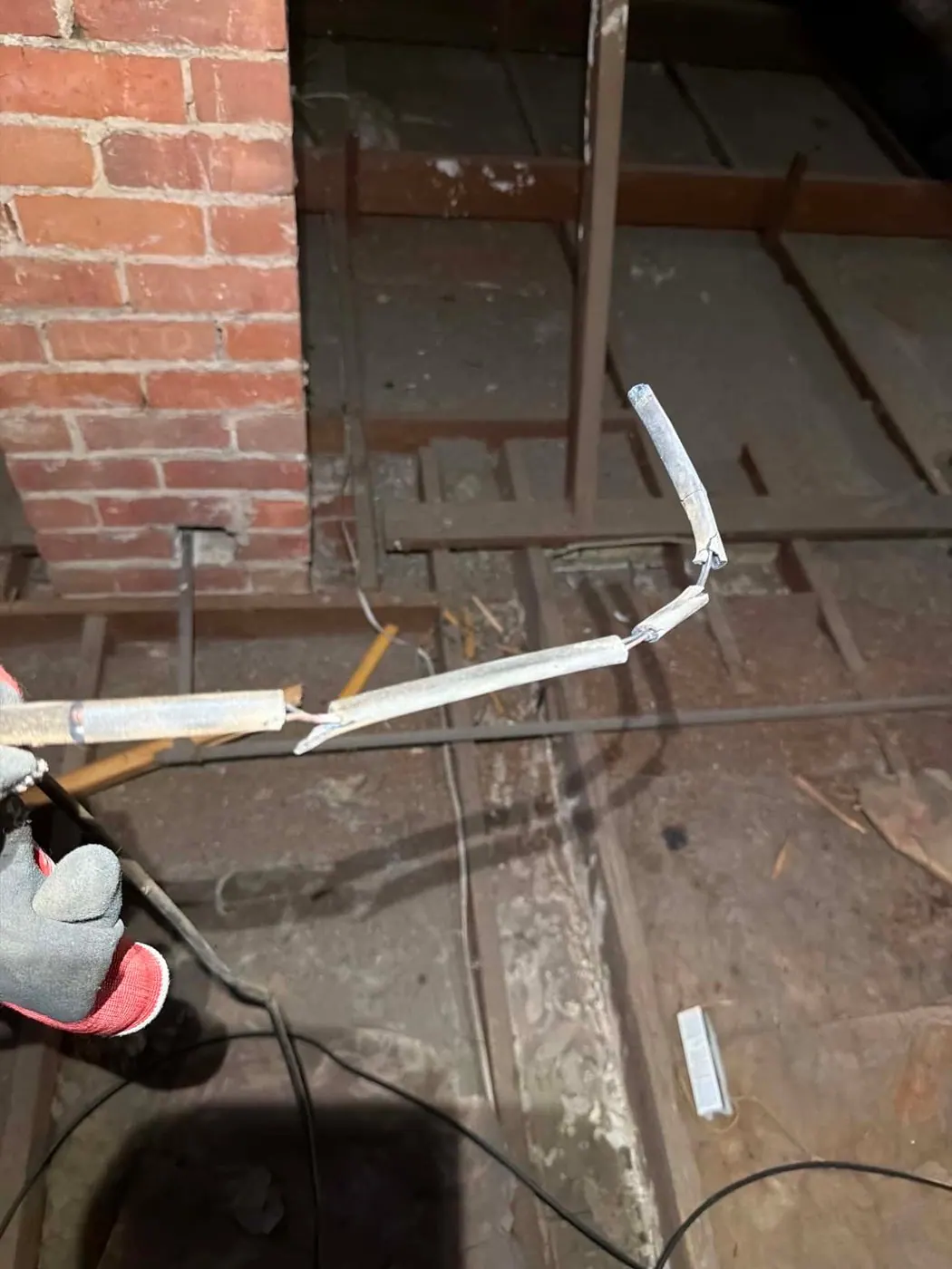 Length of perished vulcanised india rubber cable pulled out of a roof space in a 1950s Kingswood home