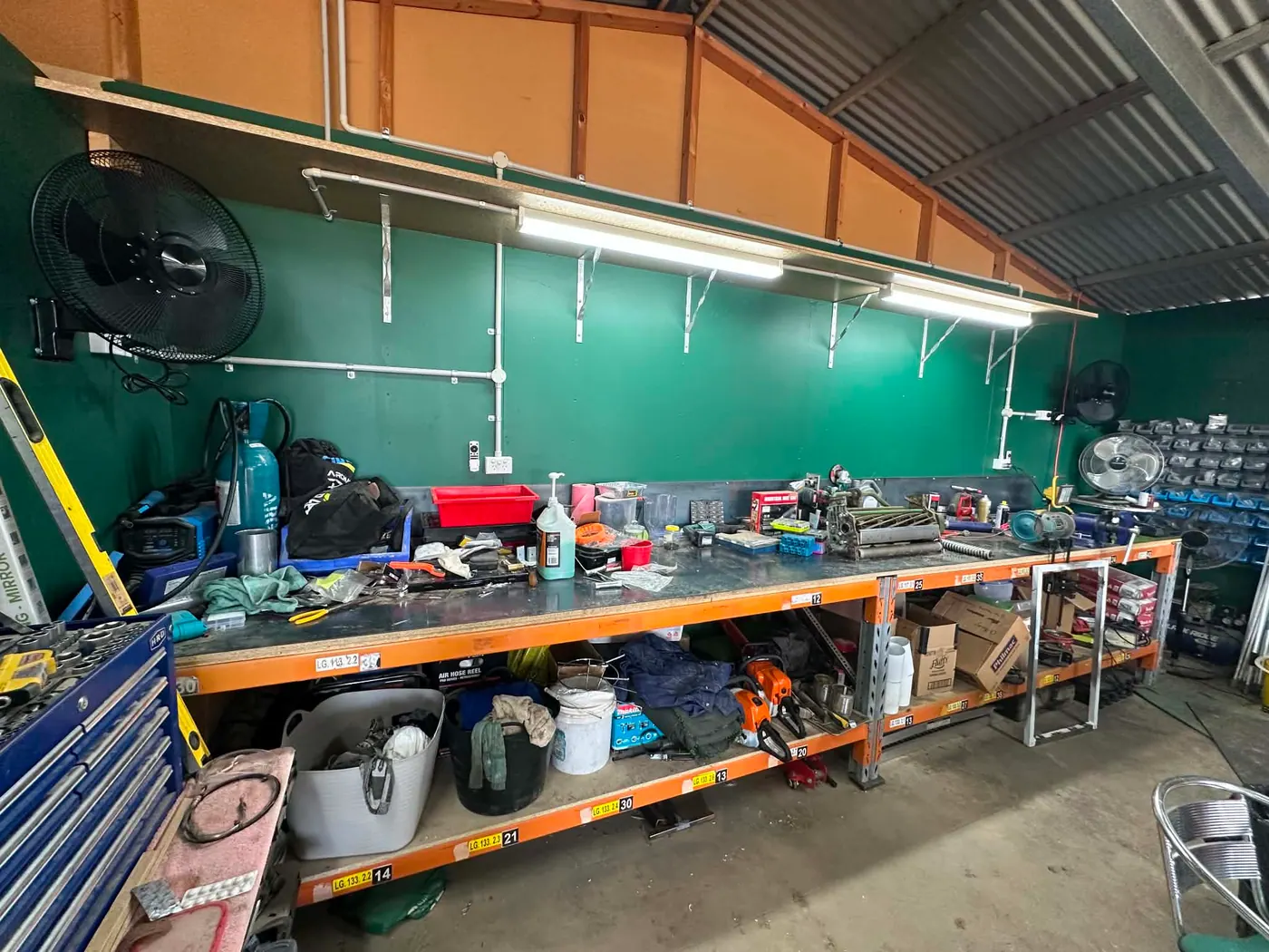 LED batten lighting over a workbench in a golf course machinery shed